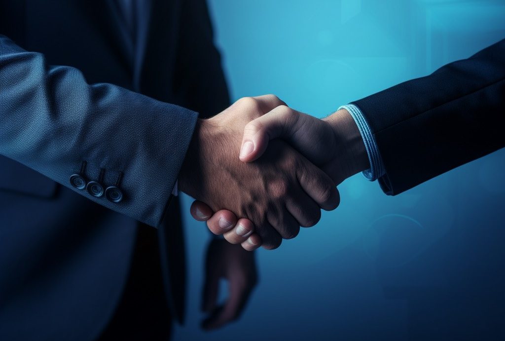 Two business people shaking hands, blue background